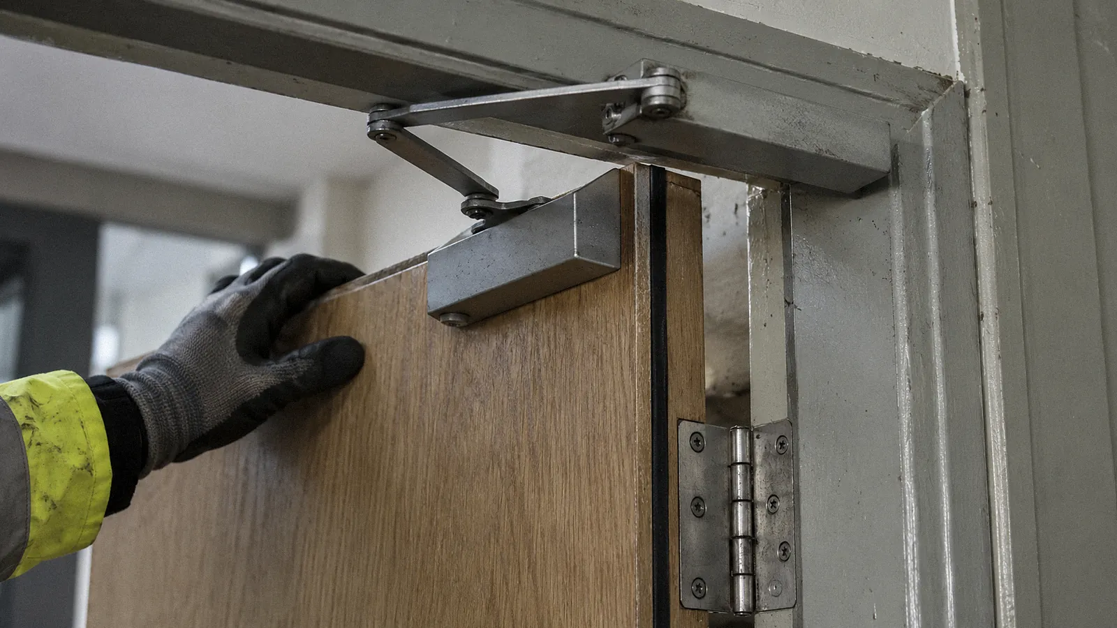 Fire door hinge and self-closer being checked